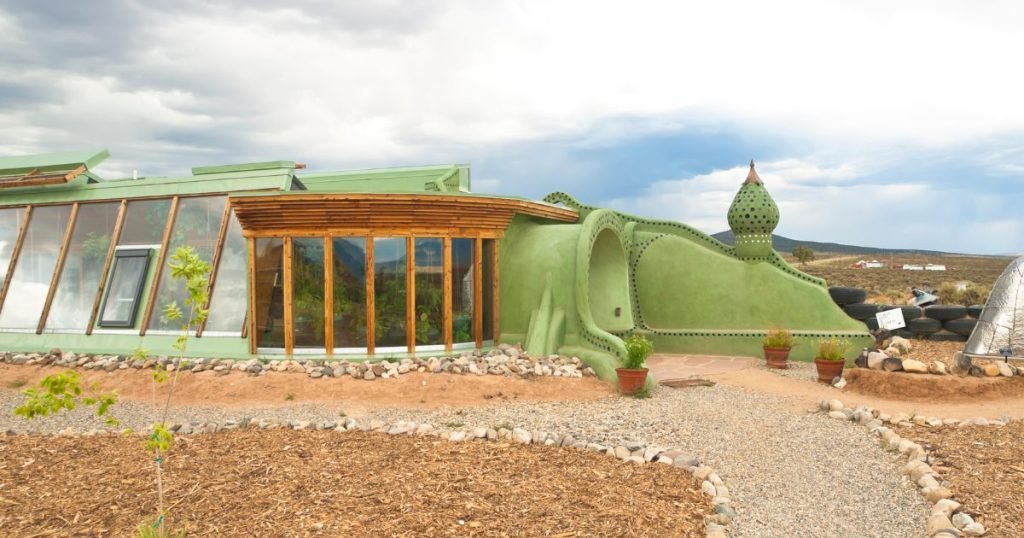 Exterior of an Earthship showing recycled materials and solar panels