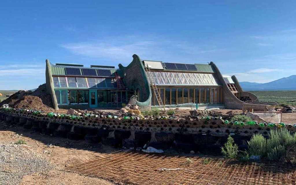 The completed Earthship in Taos, showing its unique design and materials